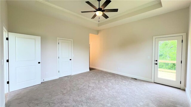 22312 W 76th St, Shawnee, KS 66227 - unfurnished bedroom featuring carpet floors, crown molding, access to exterior, a tray ceiling, and a ceiling fan