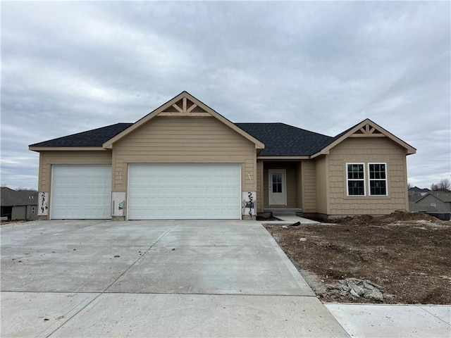 view of front of property with a garage, driveway, and roof with shingles