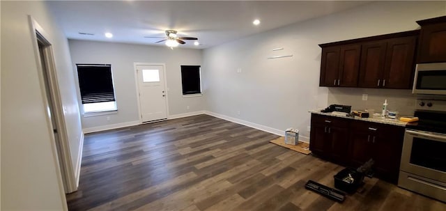 kitchen with dark brown cabinetry, baseboards, ceiling fan, dark wood-type flooring, and stainless steel appliances