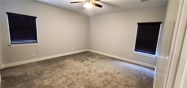 carpeted spare room with ceiling fan and baseboards