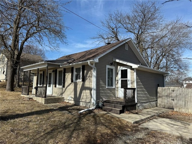 view of front of property with a porch and fence