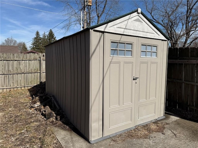 view of shed with fence