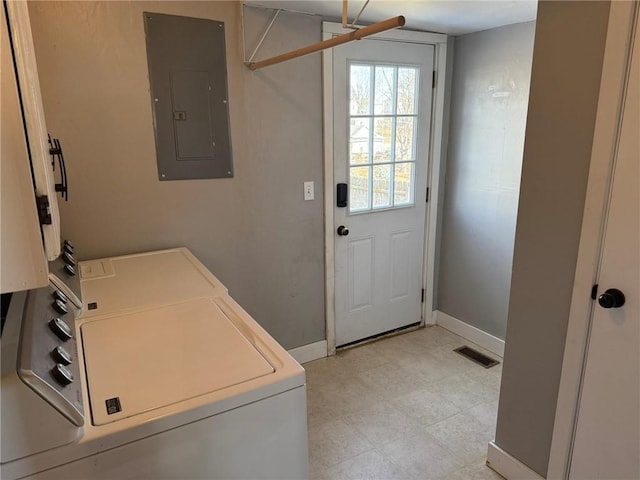 clothes washing area featuring visible vents, laundry area, electric panel, independent washer and dryer, and baseboards