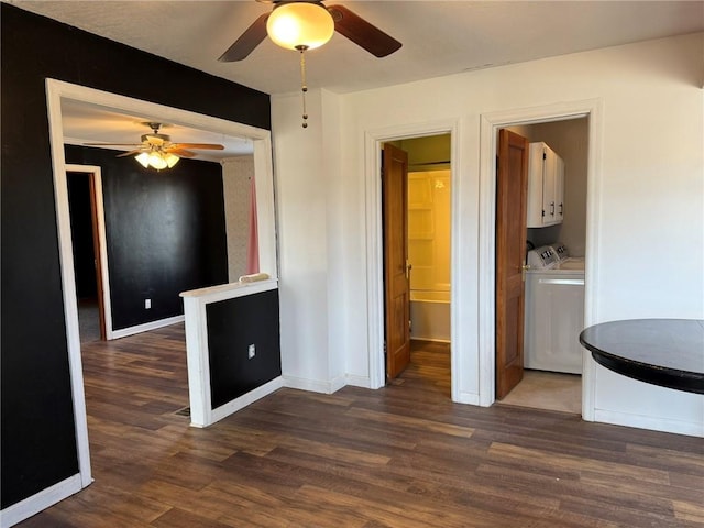 unfurnished dining area featuring washer and dryer, baseboards, and wood finished floors