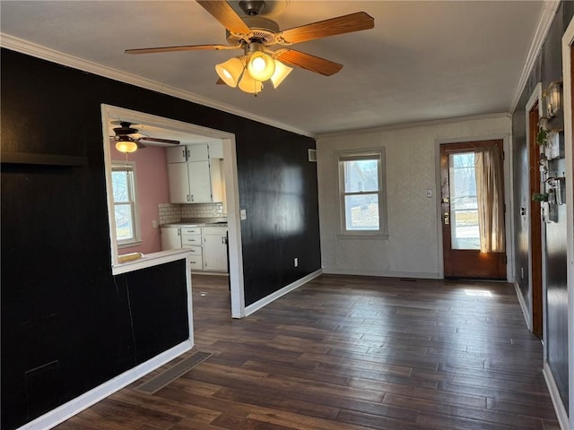 interior space with dark wood-style flooring, visible vents, white cabinets, light countertops, and ornamental molding