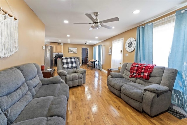 living area with a healthy amount of sunlight, recessed lighting, visible vents, and light wood-style floors