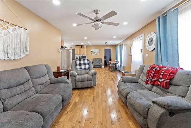 living room featuring ceiling fan, light wood-style flooring, and recessed lighting