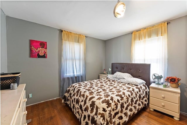 bedroom with dark wood-style flooring