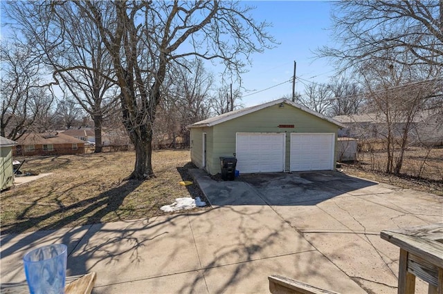 detached garage featuring fence