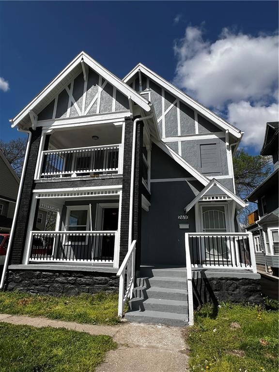 view of front of house featuring brick siding and stucco siding