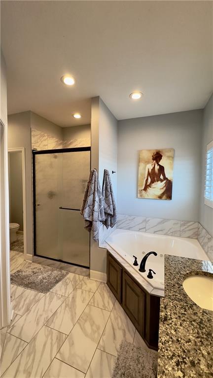 bathroom with a garden tub, recessed lighting, a sink, marble finish floor, and a stall shower