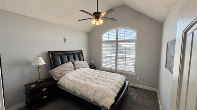 bedroom featuring lofted ceiling, dark carpet, a ceiling fan, and baseboards