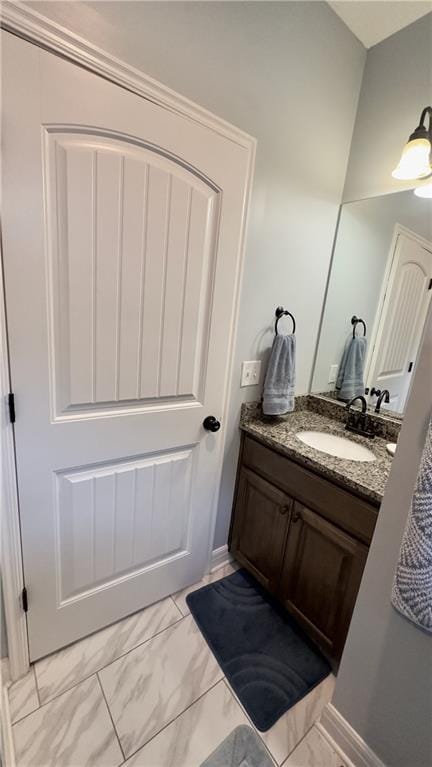 bathroom featuring marble finish floor and vanity