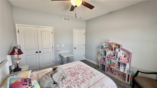 bedroom featuring visible vents, baseboards, a ceiling fan, a closet, and dark colored carpet