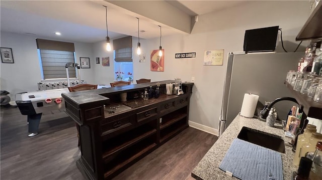 kitchen featuring dark wood-style floors, pendant lighting, recessed lighting, a sink, and baseboards