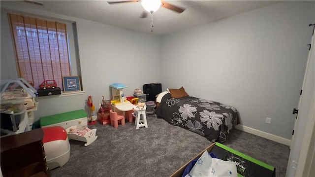 carpeted bedroom with a ceiling fan and baseboards