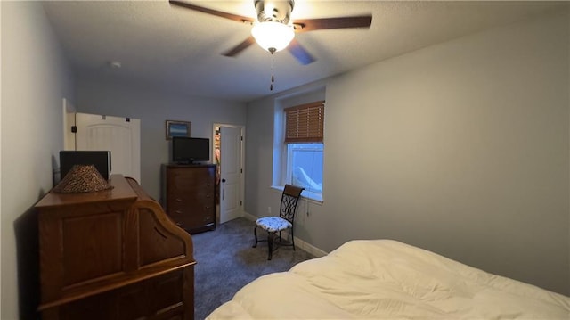 bedroom with baseboards, dark carpet, and ceiling fan