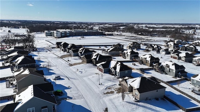 snowy aerial view featuring a residential view