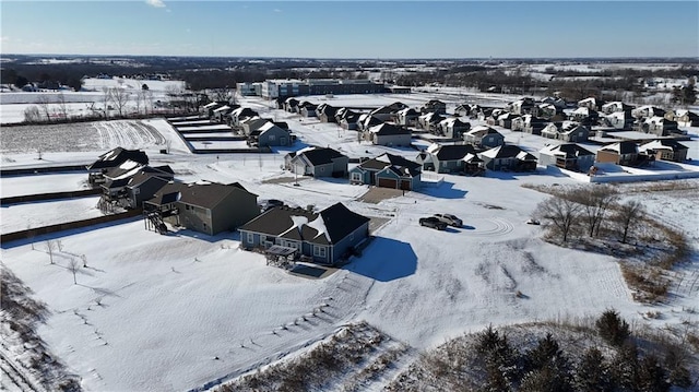 snowy aerial view with a residential view