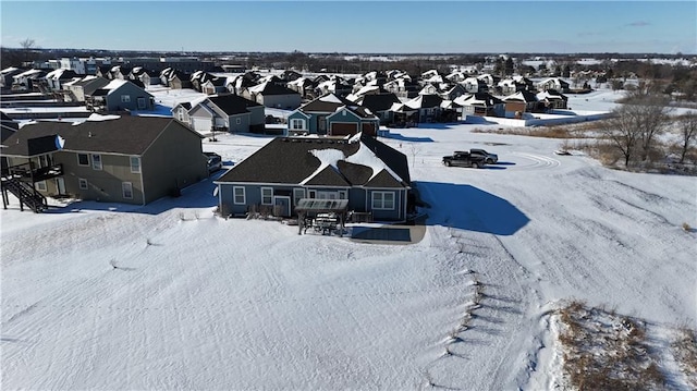 snowy aerial view with a residential view