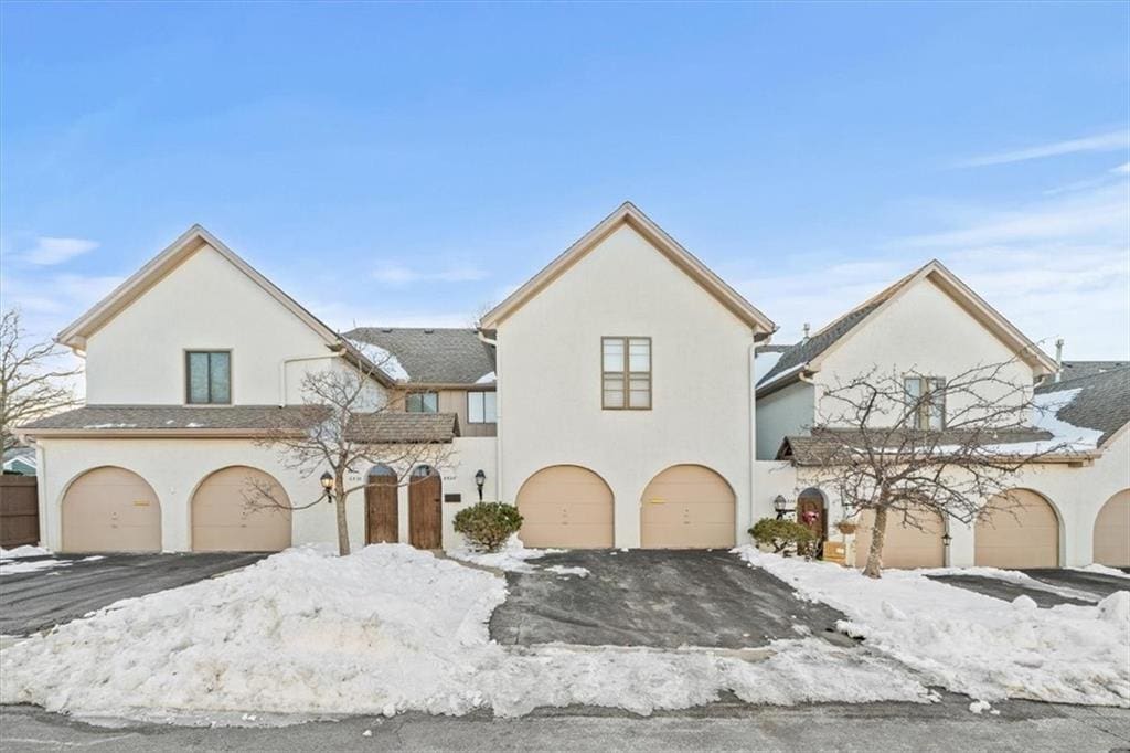 view of front of house with a garage and stucco siding