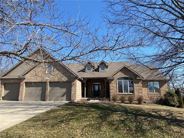 view of front of home featuring brick siding, a shingled roof, a garage, driveway, and a front lawn