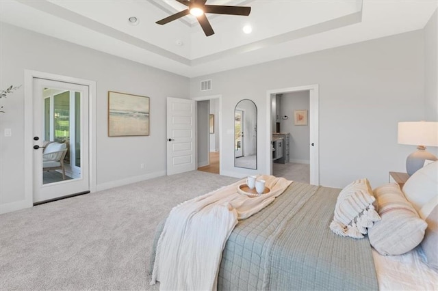 carpeted bedroom with recessed lighting, access to outside, baseboards, visible vents, and a tray ceiling
