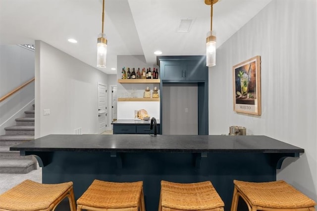 bar featuring recessed lighting, stairs, visible vents, decorative light fixtures, and indoor bar
