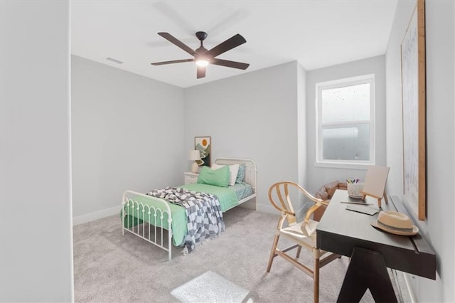 carpeted bedroom with baseboards, visible vents, and ceiling fan