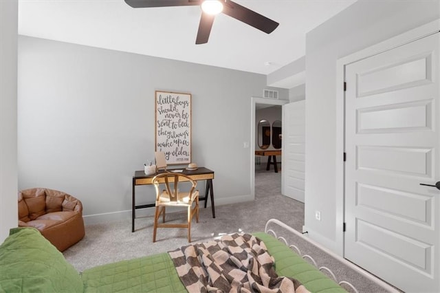 interior space with baseboards, visible vents, a ceiling fan, and carpet floors