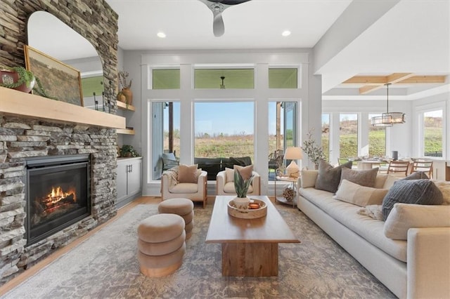 living room featuring beamed ceiling, recessed lighting, wood finished floors, and a fireplace