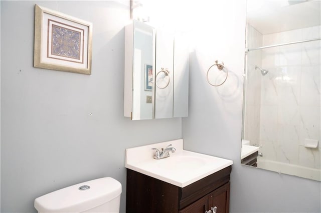 bathroom featuring toilet,  shower combination, and vanity