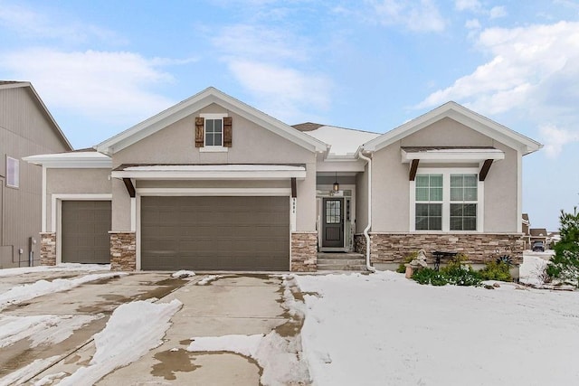 view of front of house with a garage, stone siding, and stucco siding