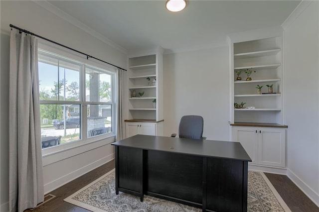 office area with dark wood-style floors, baseboards, ornamental molding, and built in features