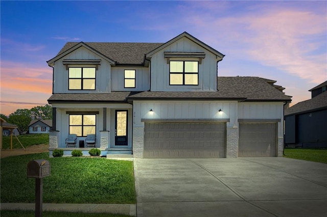 view of front of property with covered porch, concrete driveway, roof with shingles, a front lawn, and an attached garage