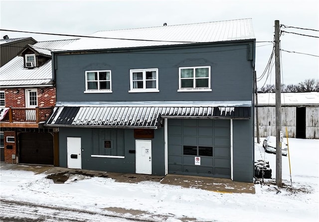 view of front of house featuring metal roof and an attached garage