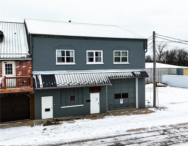 view of front of property featuring an attached garage and metal roof