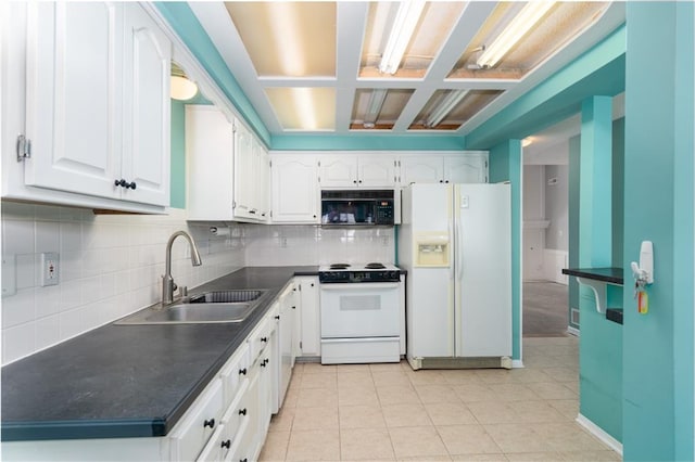 kitchen featuring white appliances, decorative backsplash, dark countertops, white cabinetry, and a sink