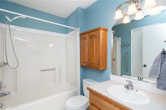 full bathroom featuring toilet, tub / shower combination, a textured ceiling, and vanity