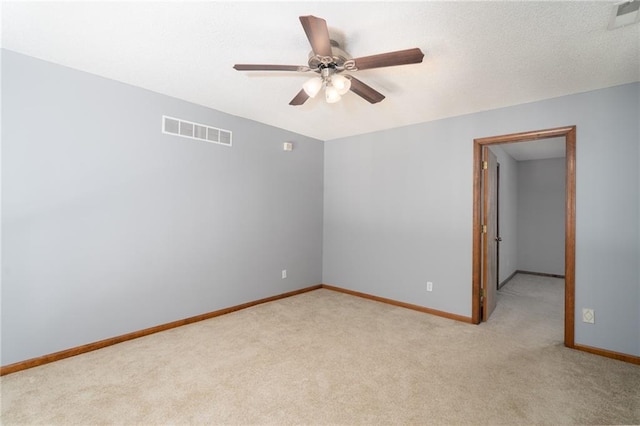 empty room featuring light carpet, baseboards, and visible vents