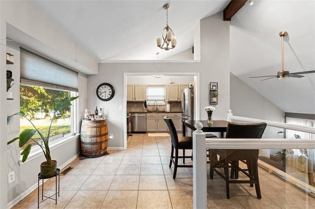 dining area with light tile patterned floors, baseboards, vaulted ceiling with beams, and ceiling fan with notable chandelier