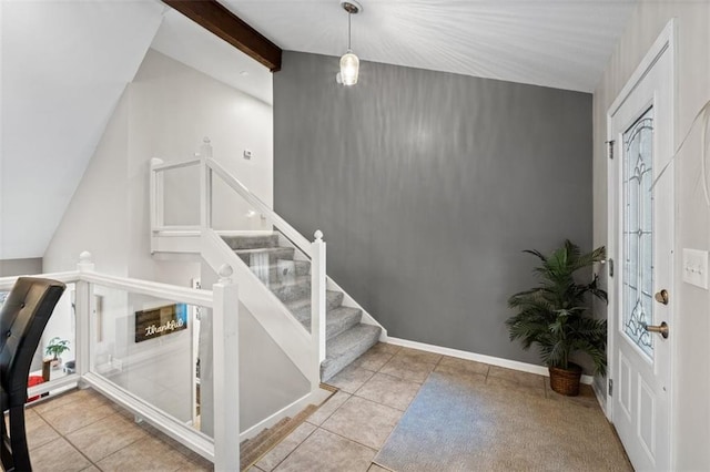 tiled entryway with lofted ceiling with beams, stairway, and baseboards