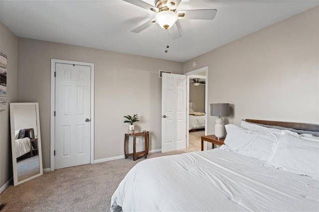 carpeted bedroom with a ceiling fan, visible vents, and baseboards