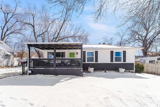 view of front of house with fence, a porch, and brick siding