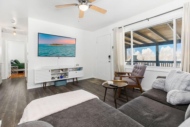 living room with dark wood finished floors, baseboards, and ceiling fan