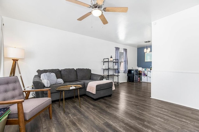 living room featuring a ceiling fan and dark wood-style flooring