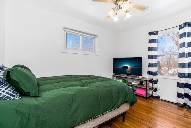 bedroom with a ceiling fan and wood finished floors