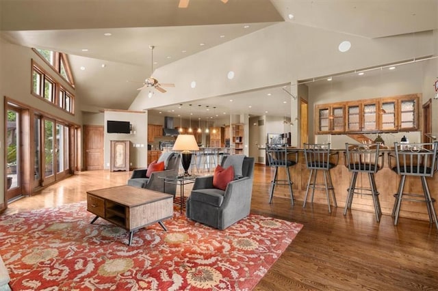 living area featuring ceiling fan, high vaulted ceiling, wood finished floors, and recessed lighting