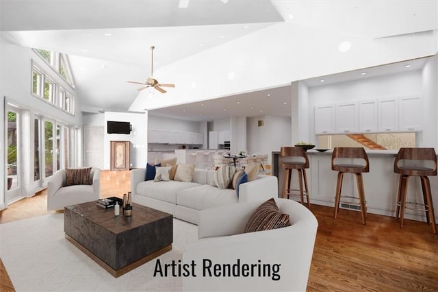 living area with high vaulted ceiling, light wood finished floors, and recessed lighting