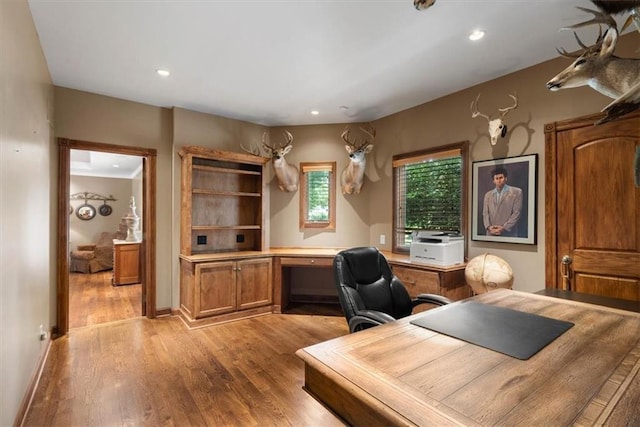 office area with recessed lighting, light wood-type flooring, and baseboards